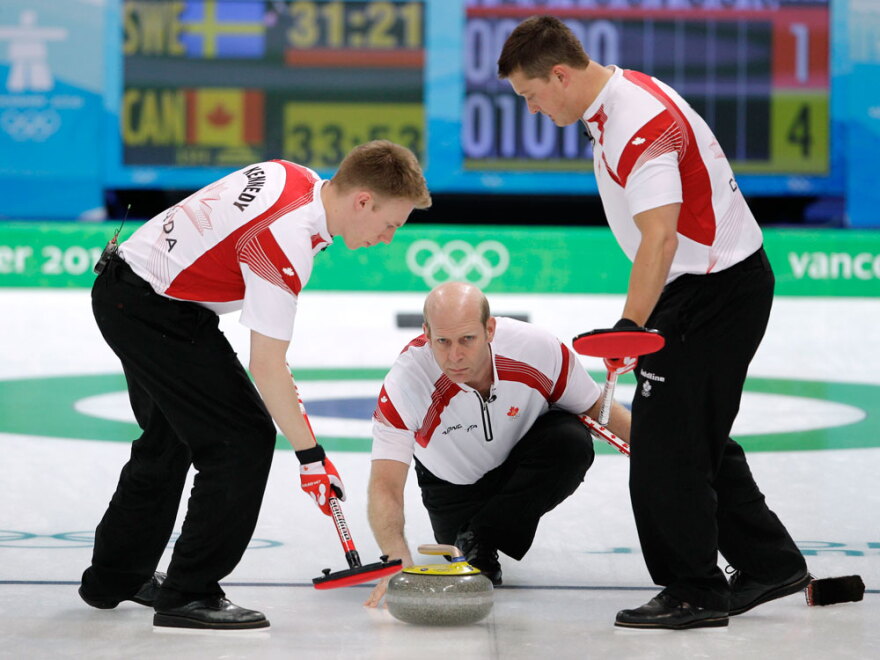 Martin delivers the stone for his sweepers Marc Kennedy (left) and Ben Hebert in the semifinal match against Sweden.