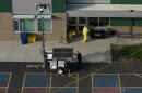 Hazardous materials workers clean up broken glass on the scene at Silver Rail Elementary School.