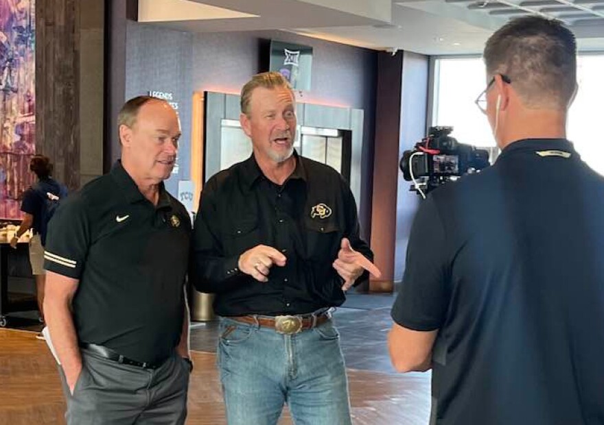 Mark Johnson (right), former radio voice of Illinois State football and basketball, interviews Colorado athletic director Rick George earlier this month.