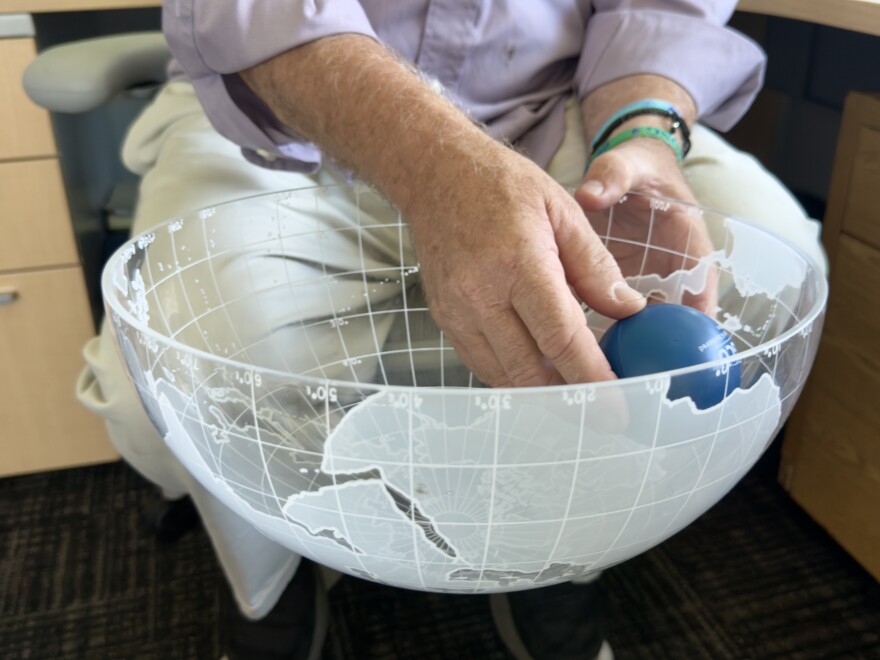 Dr. Edwin Everham, a professor of ecology and environmental studies at Florida Gulf Coast University, uses a bowl with a foam ball at the bottom, representing a mangrove ecosystem, to demonstrate to his students how long it takes for mangrove ecosystems to recover after repeated disturbances.
