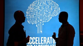 Participants at Intel's Artificial Intelligence (AI) Day stand in front of a poster during the event in the Indian city of Bangalore on April 4, 2017. (Manjunath Kiran/AFP/Getty Images)