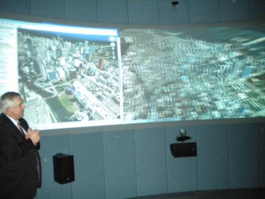 Dean Jim Ryan gives a demonstration of the 3-D visualization room 