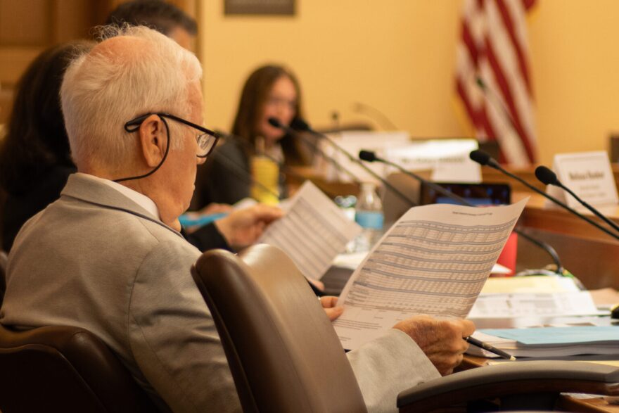Jim Porter of the Kansas State Board of Education evaluates pages of data at an Education Funding Task Force meeting on May 27, 2026.