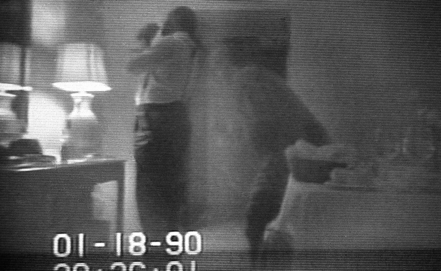 This frame from a black-and-white FBI videotape shows Barry allegedly lighting a crack cocaine pipe in a Washington hotel room in 1990. The video was played repeatedly on television newscasts around the world and used as evidence against Barry.