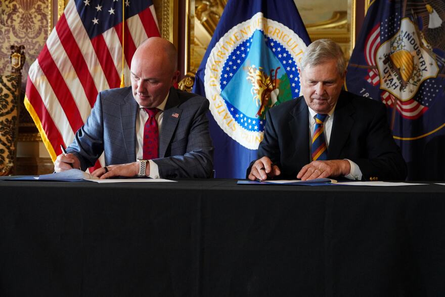 Governor Cox and Secretary Vilsack sign the Shared Stewardship agreement.