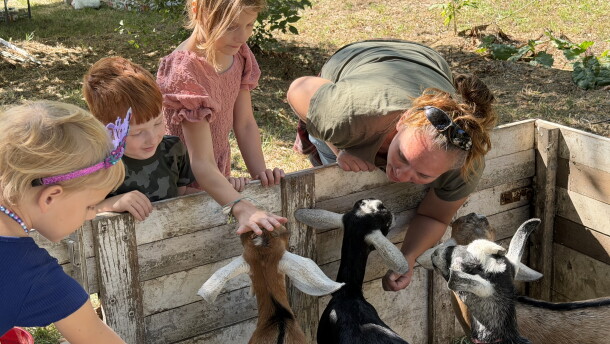 Children pet goats at Doubting Thomas Farms' harvest festival, north of Moorhead, Minn.