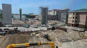 View of a construction site with lots of dirt around and cars 
