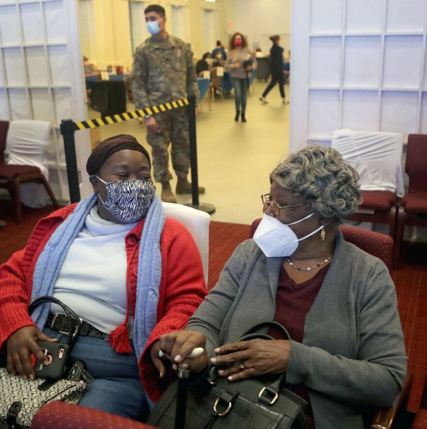 Ketley Joachim sits with her mom, Suzanne Noel, 97 from North Miami Beach after she received her vaccine during an interfaith COVID-19 vaccination drive at the Aventura Turnberry Jewish Center in Aventura Florida hosted in partnership with a mosque and Black churches on Feb. 4.