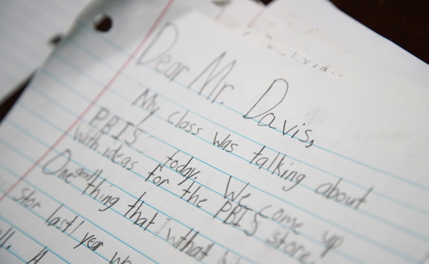 Seen on Lamont Davis' desk in Bolton Elementary School, students had written down ideas for items to include in a school store that rewards them for attendance and other positive behavior.