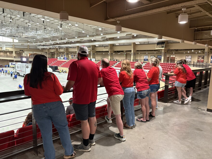 Audience members watch from the stands as a driver completes the course. Family members and friends show up to support their drivers in the competition.