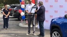 Former U.S. Ary Specialist Jesus Morales, Junior receives a flag which flew over the U.S. Capitol from Democratic Congressman Salud Carbajal of Santa Barbara. Morales received a new SUV during the event which was paid for by a veterans group, and Wells Fargo Bank.