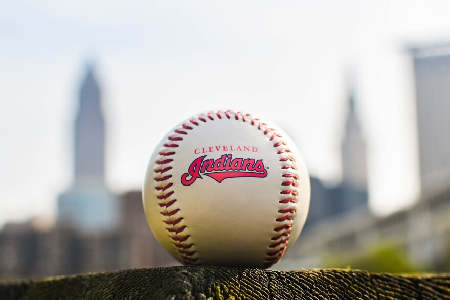 a photo of a baseball with the Indians name and logo