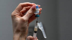 A nurse, prepares a combination measles, mumps and rubella vaccine for a patient at a pediatrics clinic in Easley, S.C. | Wisconsin Public Radio