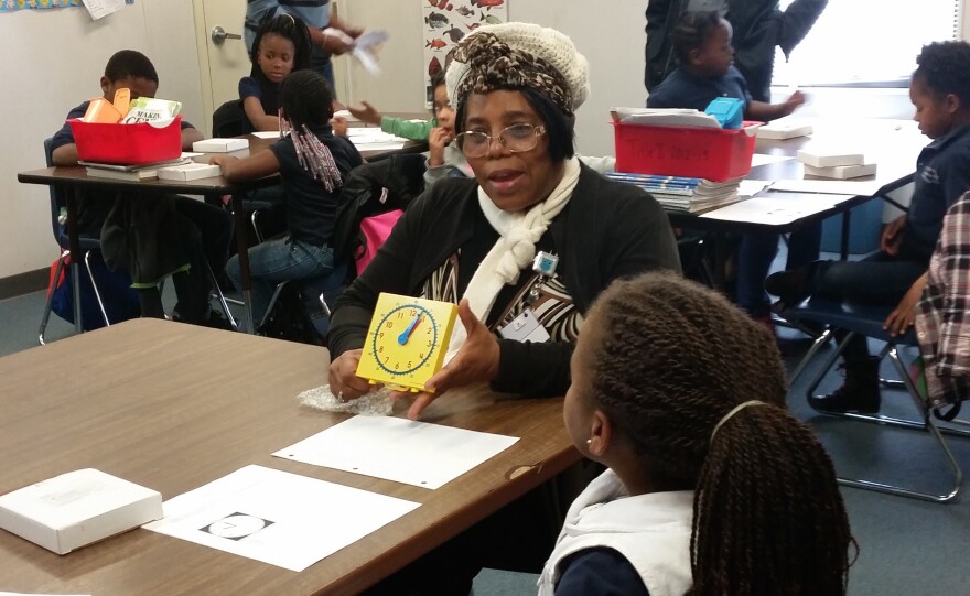 Volunteer Foster Grandparent Dorothy Thompson, 66, teaches one of her foster grandchildren how to tell time at the Caring and Sharing Learning School in Gainesville, Florida. (Photo courtesy of Megan Lang)