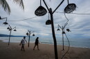 People walk on the beach after the passing of Hurricane Simon in Puerto Vallarta, Mexico, Monday, Oct. 12, 2026.