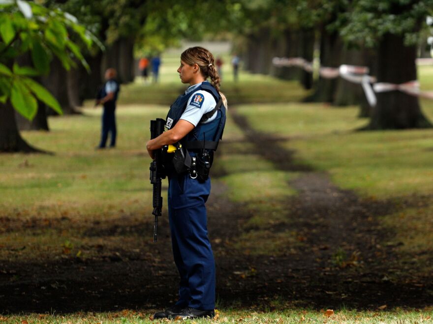 Police officers guard the area near the Al Noor mosque on Friday after a gunman killed 41 people there.