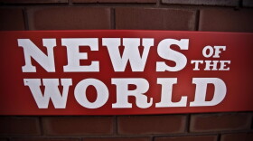 A <em>News of the World</em> sign is posted by an entrance of its parent company in London. News Corp. executive James Murdoch announced Thursday that <em>News of the World</em> will publish its last issue Sunday. A phone-hacking scandal has cost the weekly paper prestige and prompted dozens of companies to pull their ads.