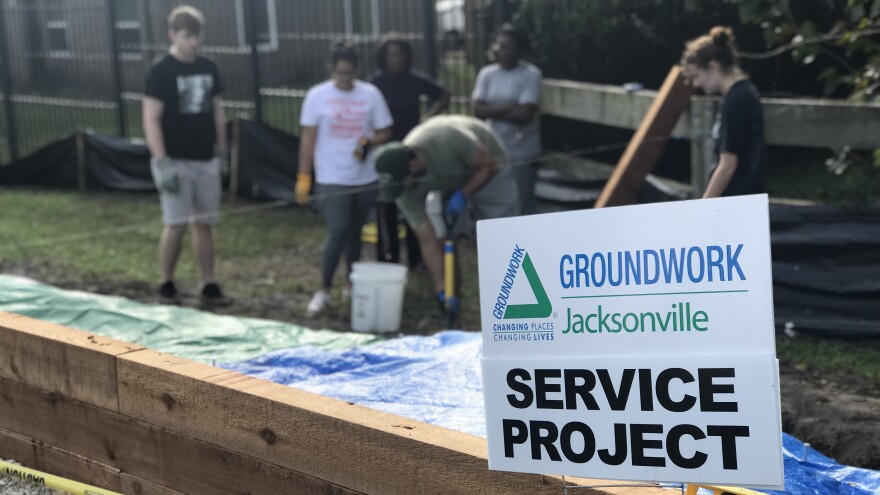 Groundwork Jacksonville volunteers from FSCJ working on a spice garden on the S-Line Biodiversity Corridor of the Emerald Trail.