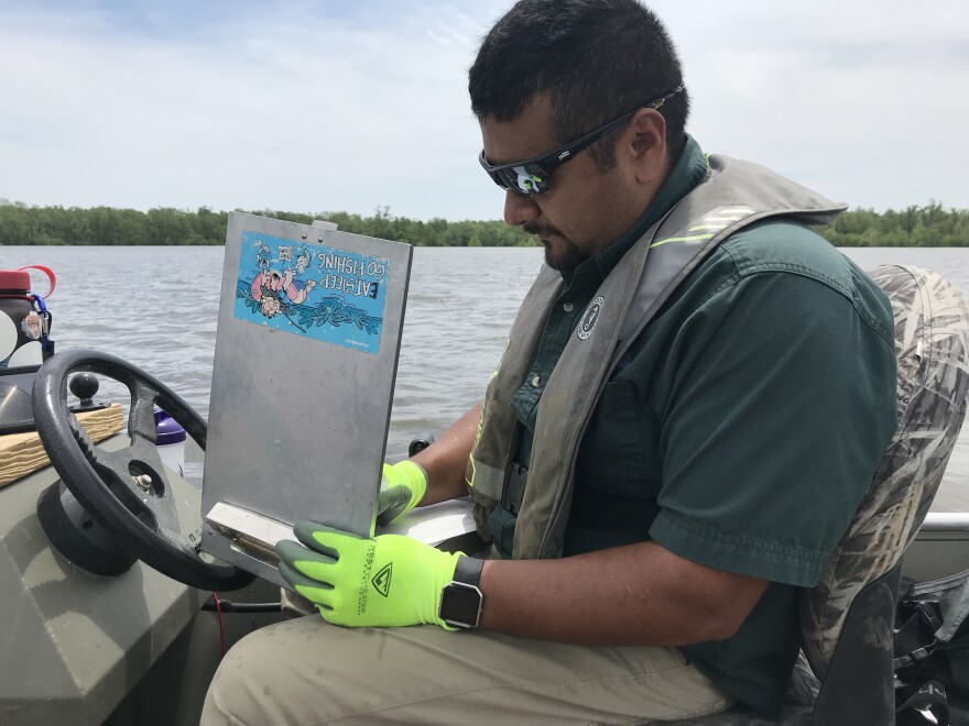 Fisheries management biologist Salvador Mondragon takes notes on the alligator gar sampling mission in May 2019.