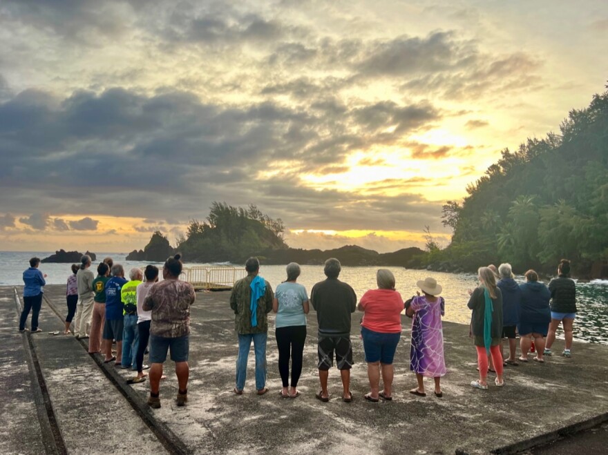 Ke Ao Hali’i board members and Hāna community members welcome the sunrise at Hāna wharf overlooking Pu’u Ka’uiki on March 28, the 5th anniversary of the establishment of the nonprofit organization.