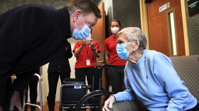 Gov. Ned Lamont greets 95-year-old Jeanne Peters, a rehab patient at a nursing facility. She was given the first COVID-19 vaccination at the nursing home on Dec. 18, 2020, in West Hartford, Conn. (Stephen Dunn/AP/Pool)