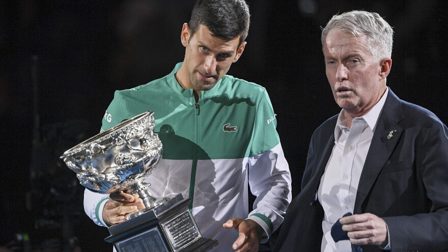 Novak Djokovic stands with Australian Open tournament director Craig Tiley during the trophy presentation at the Australian Open tennis championships in Melbourne, Australia, in February.