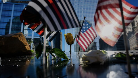Flags and roses are placed on the edge of the 9/11 Memorial Pools on the 25th anniversary of the September 11 World Trade Center attacks, Friday, Sept. 11, 2026, in New York.