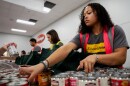 Ilencia Lightbody, a wealth management associate with Edward Jones, sorts through canned food while volunteering with Operation Food Search at the company’s headquarters on Friday, Nov. 7, 2025, in Overland.