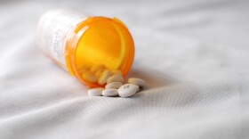 Stock photo of an open pill bottle