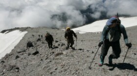 Climbing above the clouds a group of climbers, including Mount St. Helens National Volcanic Monument scientist Peter Frenzen, second from right, climbs one of the final approaches to the crater rim of Mount St. Helens Thursday, July 13, 2006. Ted S. Warren/AP