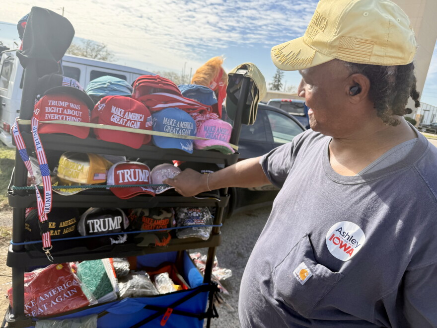 Ricardo Boyles, a South Carolina native, sells Trump merchandise outsidea rally in Sioux City on Oct. 22.