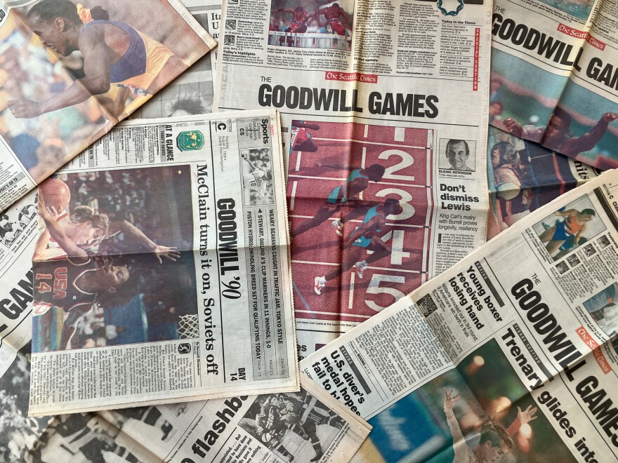Layered newspapers showing headlines from the 1990 Goodwill Games. 