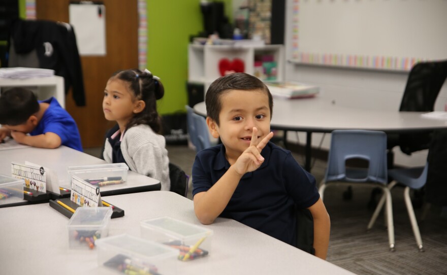 This kindergartener in Miss Pescina's class gave a peace sign for the camera.