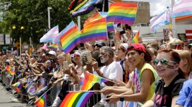 A crowd holds rainbow flags as they watch the 48th Annual Chicago Pride Parade on Sunday, June 25, 2017 in Chicago
