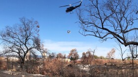 A helicopter conducts aerial seeding along the Bear Creek Greenway on Oct. 19.