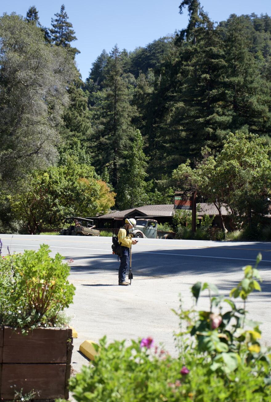 Battalion Chief Jordan Abeel with the San Marcos Fire Department waits for his ride outside the Ripplewood Resort general store.
