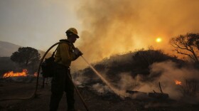 A firefighter battles a wildfire near Placerita Canyon Road in Santa Clarita, California, Sunday, July 24, 2016. (Ringo H.W. Chiu/AP)