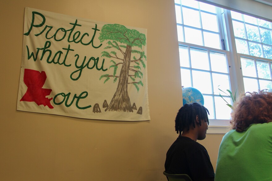 In Alicia Cooke’s classroom, a homemade banner with a cypress tree says “Protect what you love.” The L is shaped like Louisiana.