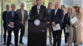 A man at a podium in front of several other people