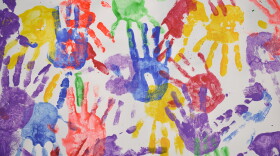 Colored handprints on a blank background
