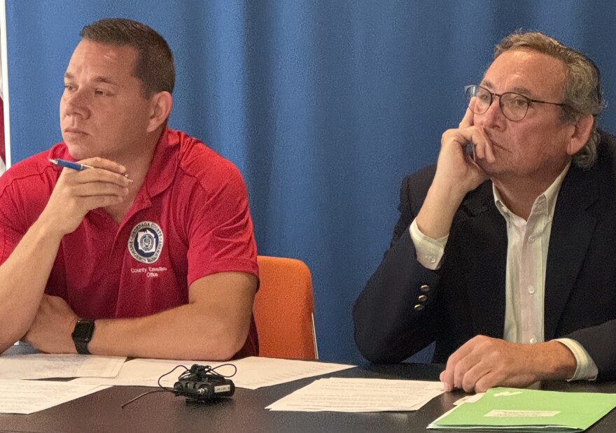 Onondaga County Executive Ryan McMahon, left, and County Attorney Robert Durr listen at the public hearing Wed 7-16-26.