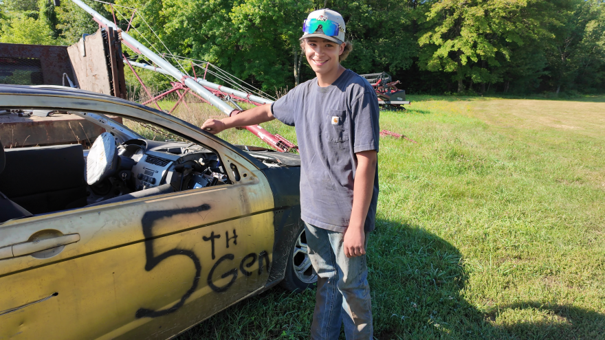 Fifteen-year-old Ben Morrill shows off his '08 Ford Focus. Drivers come up with their own numbers for their vehicles. Ben chose “5th Gen” to represent that he is a fifth-generation dairy farmer.