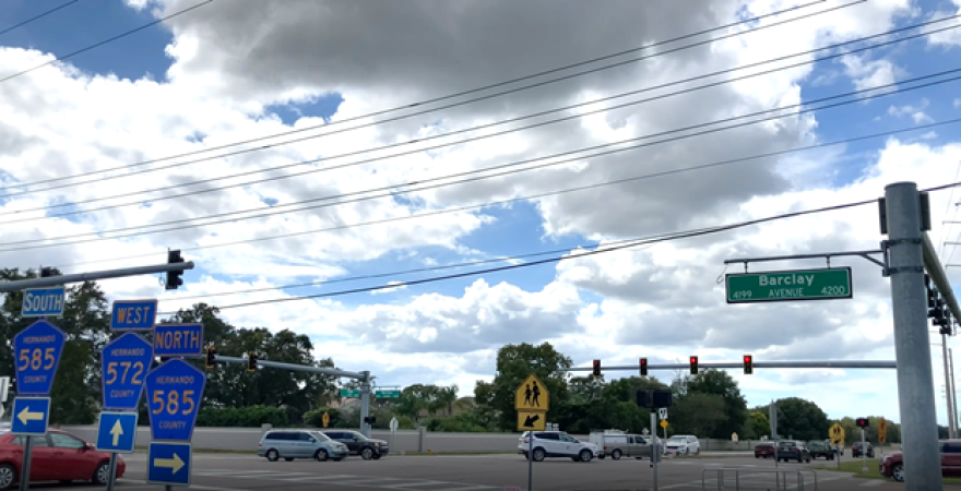 road signs next to an intersection 