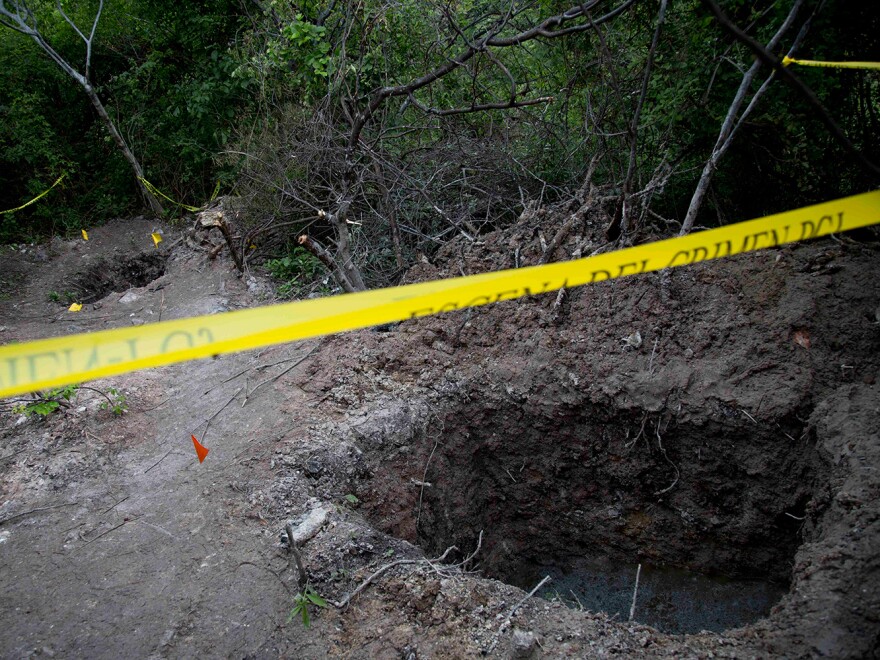 Clandestine graves are seen near Iguala on Monday. State officials have been unable so far to determine whether the 28 bodies found in the graves are of the students who were attacked by local police.