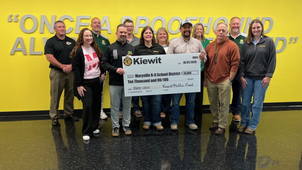 Maryville school district and Kiewit Corporation employees gather for a check presentation at Maryville High School October 1, 2026. Holding the check are (L-R) Maryville school district superintendent Philip Pohren and Heather Bowen and Ryan Mondragon of Kiewit Corporation.