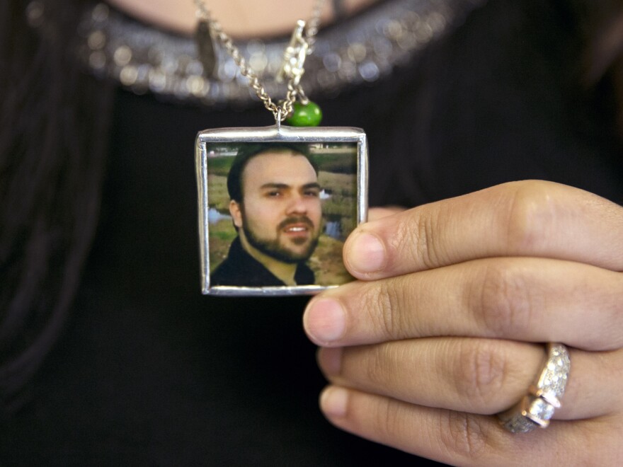 Naghmeh Abedini holds a necklace with a photograph of her husband, Saeed Abedini, on June 2.