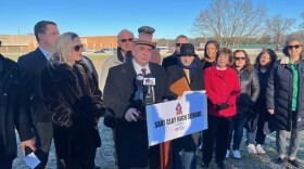 Sen. Linda Rogers, dressed in red, pictured at a December 2023 press conference organized by charter school owner Larry Garatoni, in his efforts to acquire the recently closed Clay High School for a new charter school.