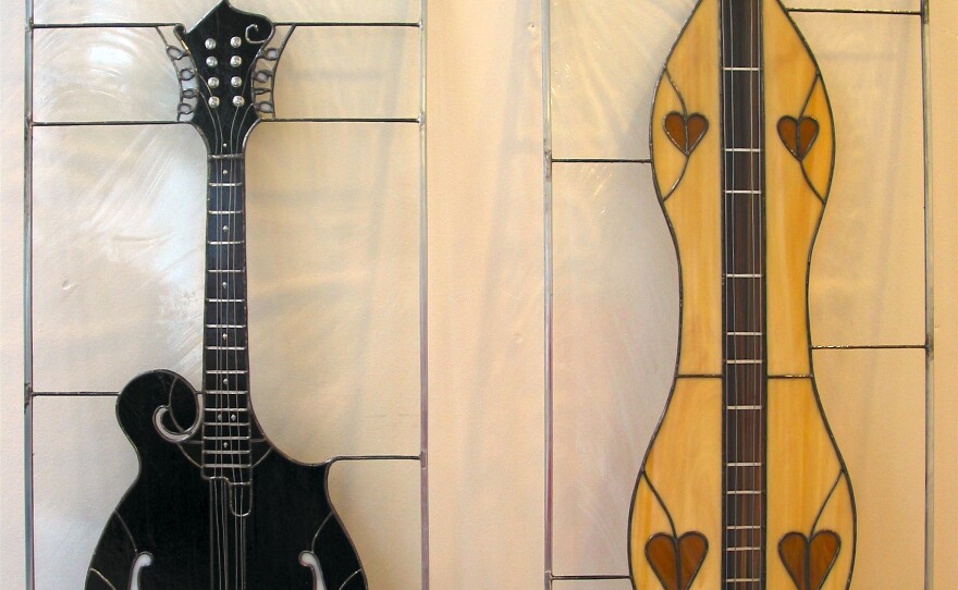 A mandolin and a dulcimer represented in stained glass by Joby Shimomura.