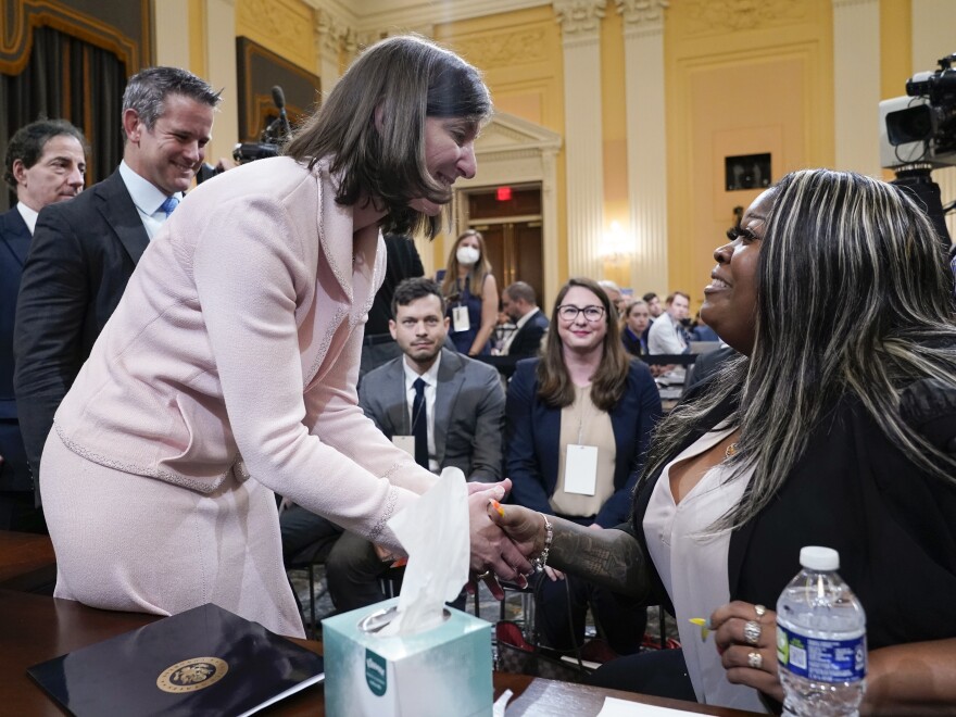 Rep. Elaine Luria, D-Va., greets Wandrea "Shaye" Moss, a former Georgia election worker, after she testified at the House select committee investigating the Jan. 6 insurrection on Tuesday as committee members Reps. Adam Kinzinger, R-Ill., and Jamie Raskin, D-Md., wait their turn.