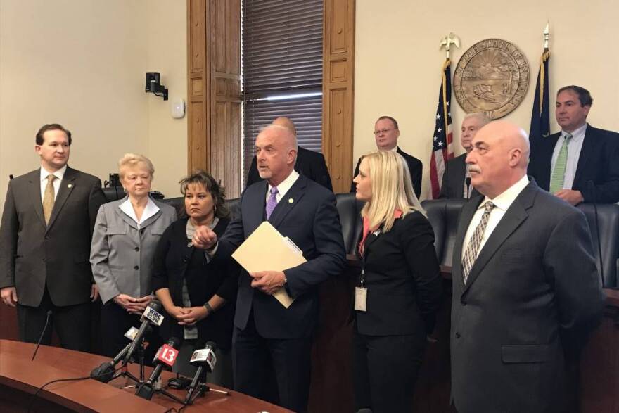 Baby box supporters, led by Sen. Travis Holdman (R-Markle), center, discuss the baby box expansion bill at the start of the 2018 session.